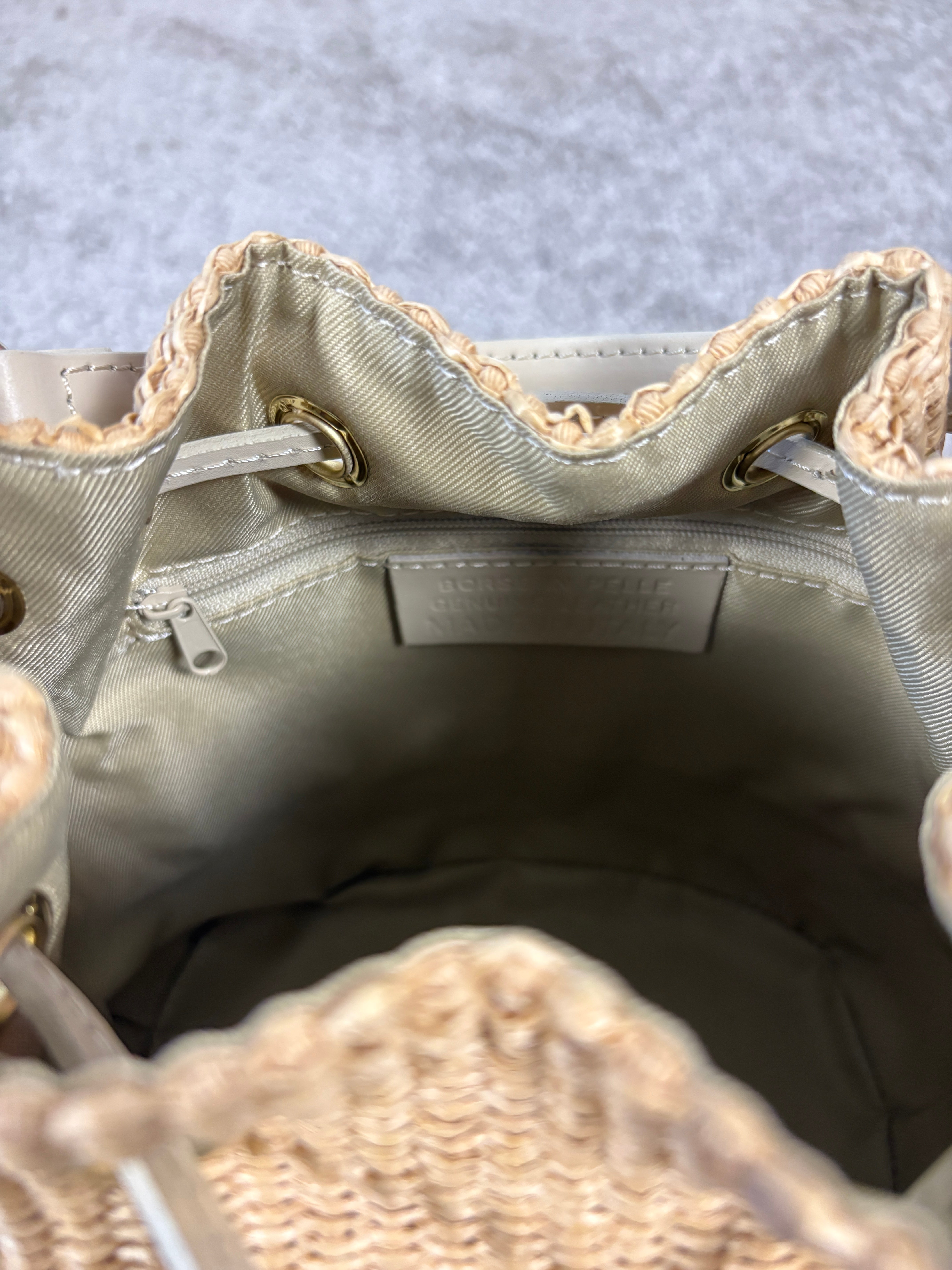Woven bucket bag with leather details